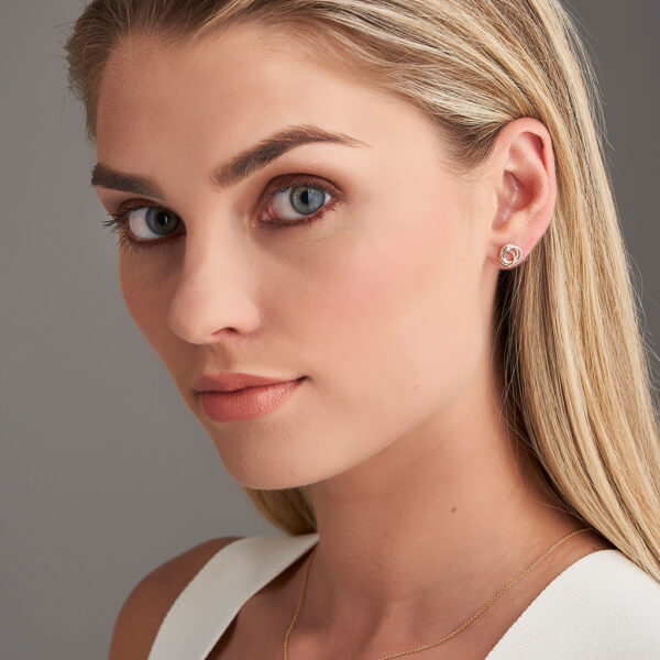 woman wearing intertwined earrings