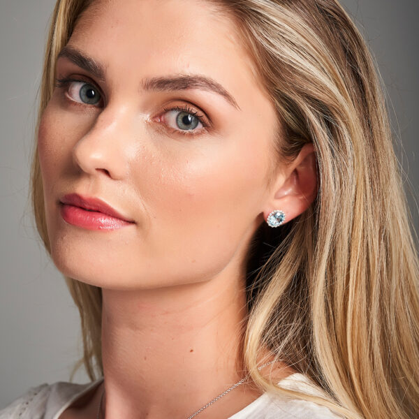 woman wearing blue topaz earrings