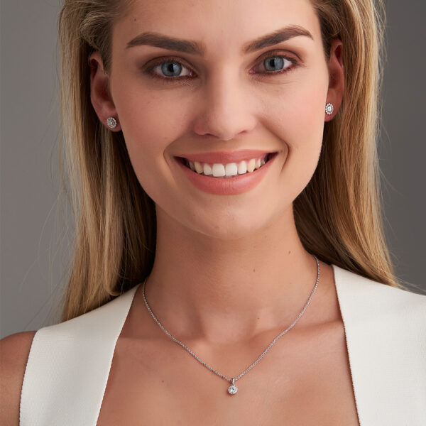 woman wearing halo pendant and earrings