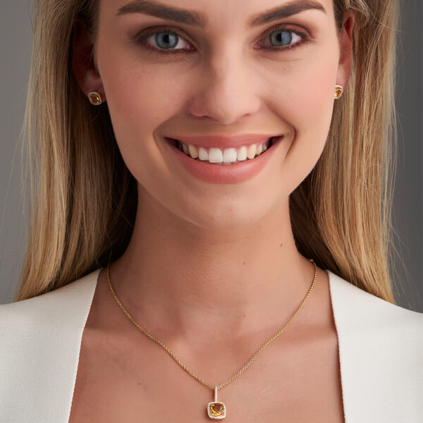 woman wearing citrine earrings and pendant