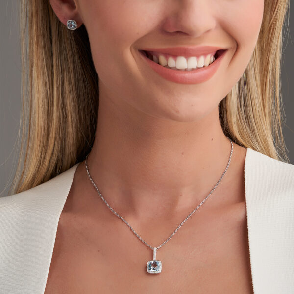 woman wearing blue topaz earrings and necklace