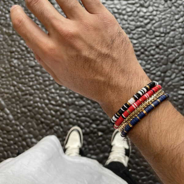 man wearing 4 bracelets