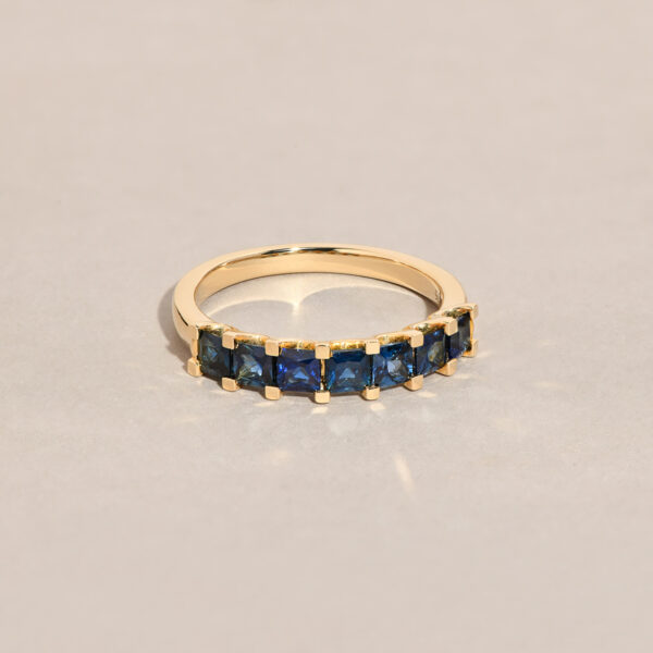Iris ring with seven princess cut blue Australian sapphires set in 9k yellow gold