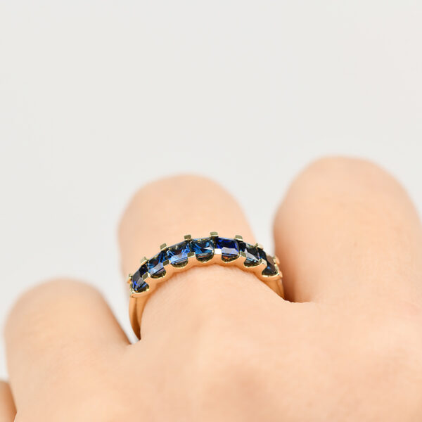 Iris ring with seven princess cut blue Australian sapphires set in 9k yellow gold