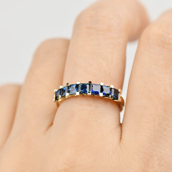 Iris ring with seven princess cut blue Australian sapphires set in 9k yellow gold