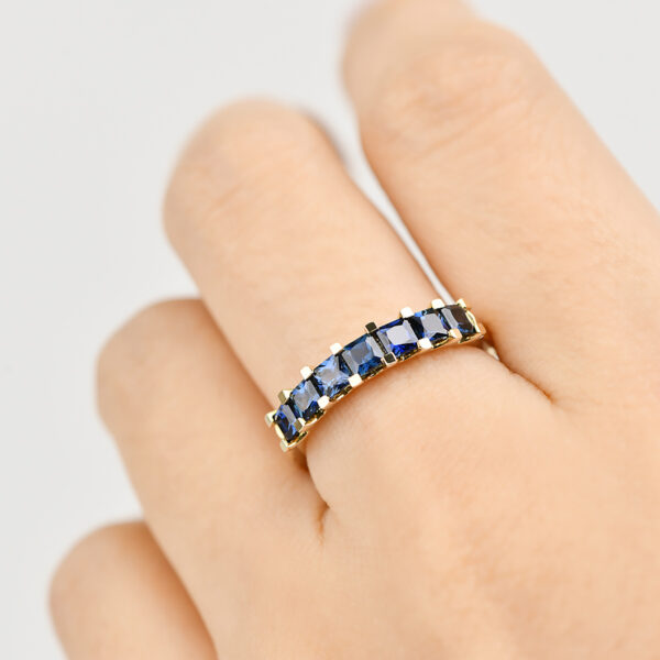 Iris ring with seven princess cut blue Australian sapphires set in 9k yellow gold