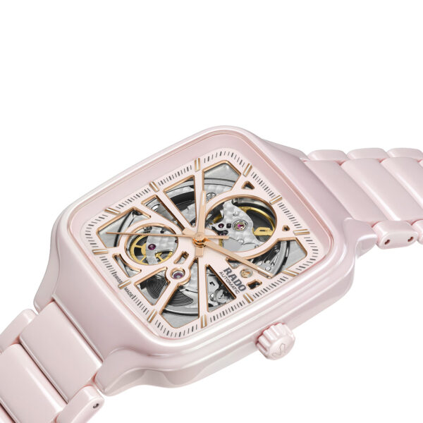 front side view of a Rado True Square Open Heart watch in rose high-tech ceramic with skeleton dial and ceramic bracelet – model R27123012