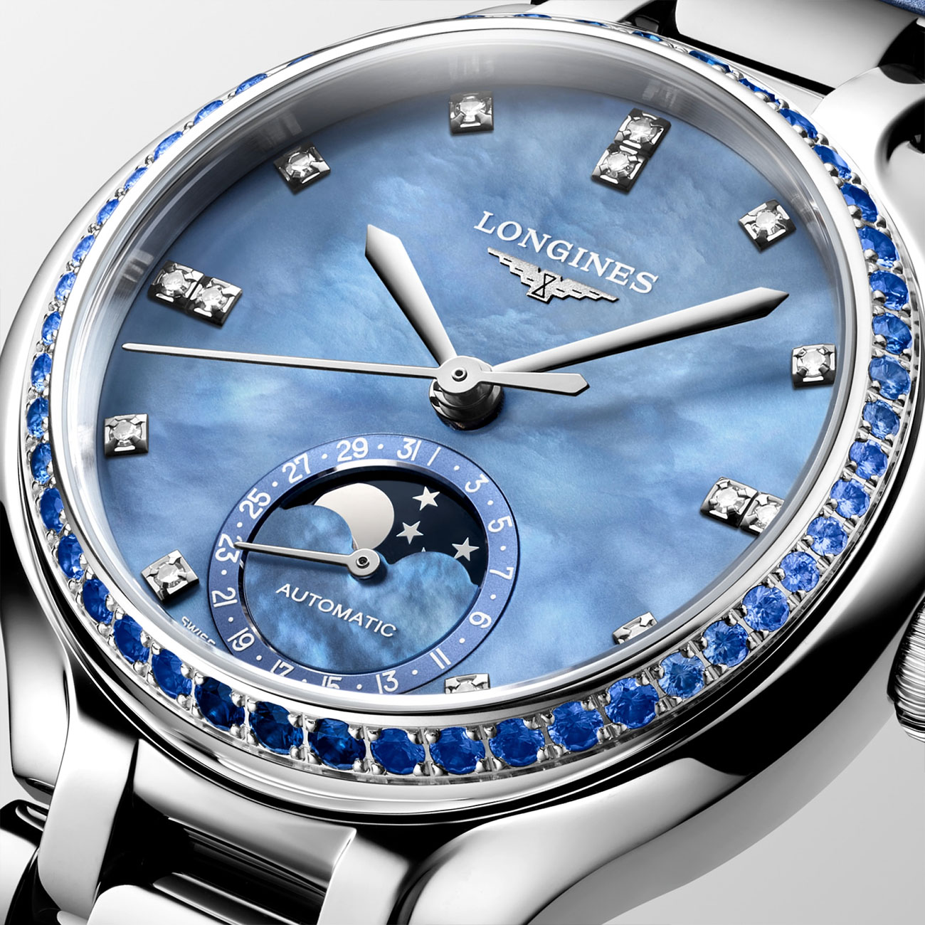 watch-collection-longines-primaluna-moonphase-l81260972-dialclose Longines Primaluna Moonphase 34mm L81260972 with diamond indices, blue sapphire bezel, blue mop dial & blue alligator leather strap - close up dial